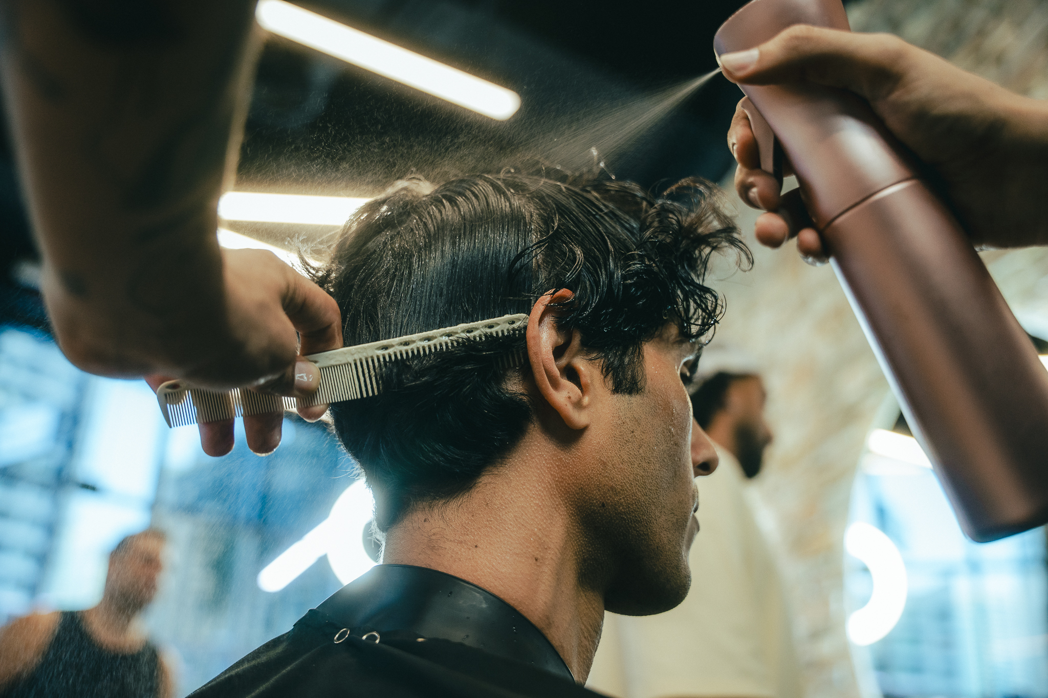 Barber performing a precision haircut and fade in a Dubai barbershop