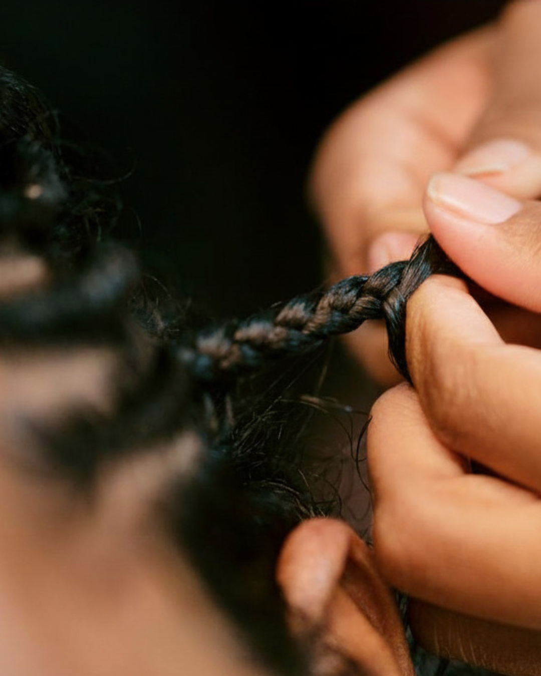Barber doing an edge up and line up on a man with braids