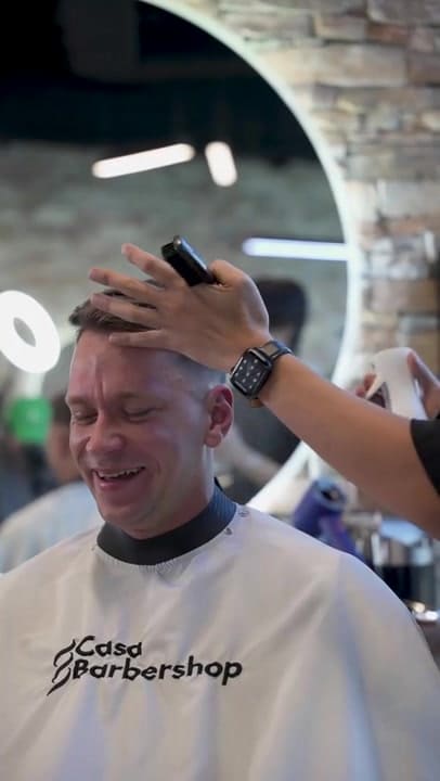 Happy client in a Casa Barbershop cape